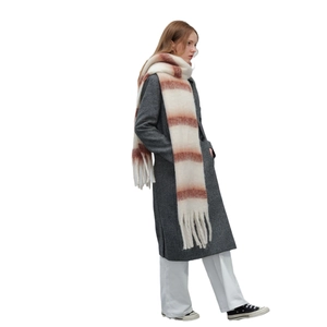 Thick warm winter scarf with striped pattern and long tassels on cream background