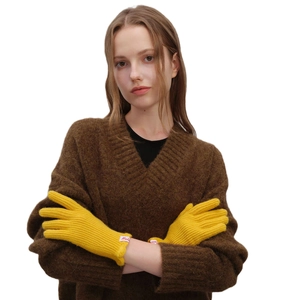 Women's warm yellow wool knit gloves with elastic ribbed cuffs and Mula brand label