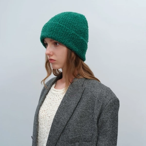 Deep green textured knit beanie hat with fuzzy teddy fleece finish for winter warmth