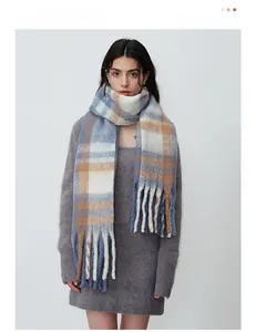 Close-up of thick plaid cashmere-like scarf with long tassels and soft brushed texture