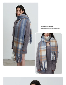Detail of blue and brown checkered scarf with thick fringe and brushed mohair texture