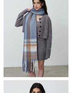 Detail of blue and orange plaid scarf texture with soft fringe and plush faux cashmere