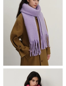 Detail of lavender cashmere scarf with white contrast stitching and long fringes