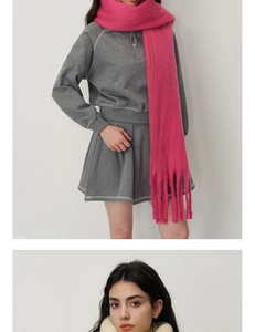 Detail of thick cashmere-like scarf showing soft plush texture and long fringe tassels