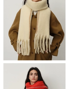 Detail of thick cashmere-like scarf with contrast stitching and long fringe tassels