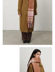 Detail of pink and brown plaid thick scarf with fringes and fluffy cashmere texture