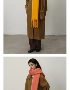 Detail of soft thick cashmere-like scarf with fringe edges in yellow and orange colors