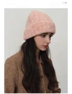 Detail of chunky pink knit wool beanie featuring warm texture and thick ribbed cuff design