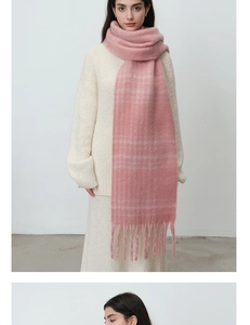 Close-up of pink checkered scarf with soft mohair texture and long tassel fringe details