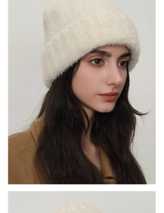 Close-up of thick ribbed knit beanie showing soft wool texture and wide folded brim