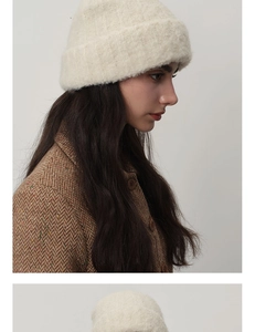 Detail shot of off-white chunky knit wool beanie with rich texture and warm fuzzy finish