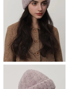 Detail of purple chunky knit beanie paired with brown herringbone tweed coat and wooden buttons