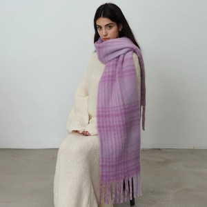 Chunky lilac checkered knit scarf with long tassels paired with a white knit dress