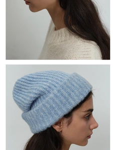 Detailed close-up of light blue chunky knit beanie showing soft wool blend texture