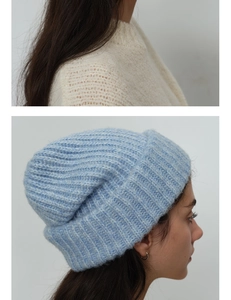 Detail of light blue knit beanie showing plush wool blend texture and ribbed cuff design