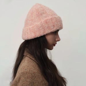 Pink plush wool knit beanie for women featuring a thick folded brim and warm fluffy texture