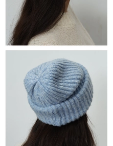 Close-up of light blue ribbed knit texture on a warm wool blend winter beanie hat