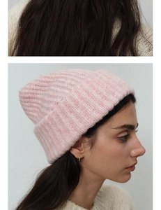 Detail of pink wool knit beanie showing chunky texture and ribbed folded cuff design