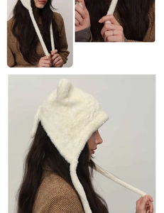 Detail shot of white fuzzy earflap hat with cute ears and long ties for winter styling