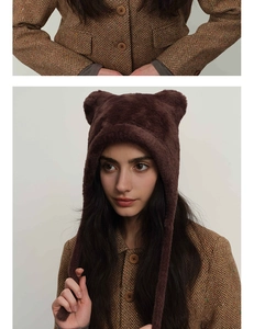 Close-up of soft brown faux fur winter hat with cute bear ears and long earflaps