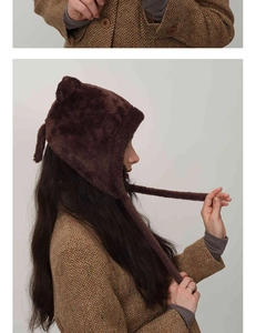 Detailed view of plush dark brown earflap hat with cute cat ears for winter