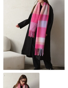 Macro detail of plaid scarf with thick tassels in pink, purple, and orange hues