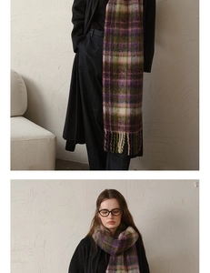 Detail showing the plaid pattern texture and long fringes of a mohair-style winter scarf