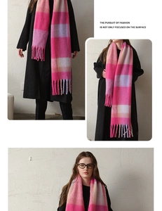 Macro view of thick checkered scarf showing soft texture and pink fringed tassels