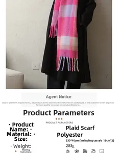 Detail of pink and purple plaid scarf showing thick tassels and warm cashmere-like texture