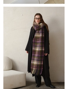 Detail of soft mohair plaid scarf in purple and green with thick tassels for winter