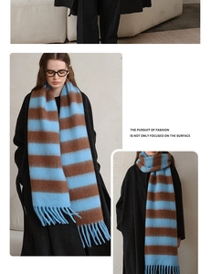 Detail of blue and brown striped acrylic scarf featuring fringe ends and soft texture