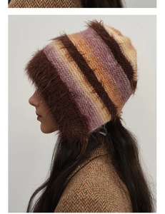 Detail of colorful gradient knit hat featuring warm faux fur trim and braided design