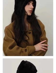 Detail of black faux fur winter earflap hat with soft texture and chic cat ear design