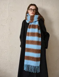 Detailed close-up of blue and brown striped acrylic scarf with thick tassel edges