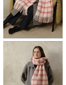 Detailed macro view of the soft pink and white plaid wool scarf with decorative long tassels