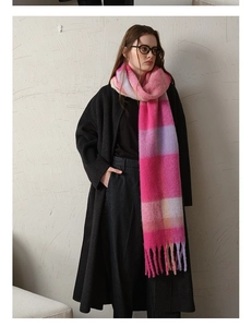 Close-up of pink and purple checkered cashmere-like scarf with long fluffy tassels