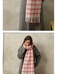 Close-up of pink and white checkered wool scarf showing soft knit texture and fringe details