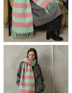 Detail of pink and green striped acrylic scarf showing soft fuzzy texture and long tassels