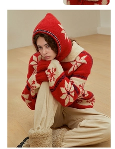 Close-up of red and beige snowflake knit balaclava showing thick wool texture