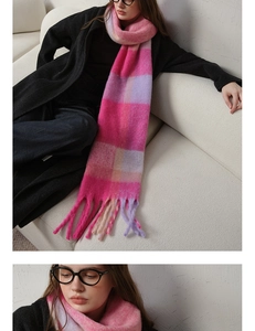 Detail of warm pink and purple plaid scarf with thick tassels and soft cashmere texture