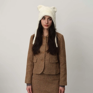 Cute white plush bear ear hat for winter warmth with cozy earflaps and soft texture