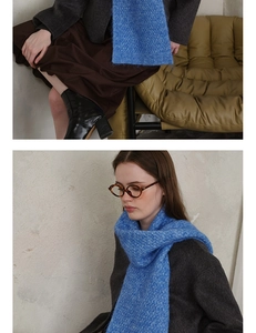 Detail of blue diamond knit scarf texture paired with wool coat and brown skirt