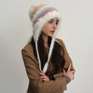 Rainbow striped knit hat with white faux fur ear flaps and long braids for winter