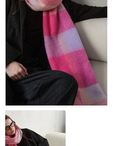 Detail view of pink and purple plaid scarf with thick tassels and plush texture fabric