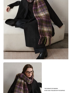 Detailed macro view of the thick plaid scarf featuring soft mohair fringe and tassels
