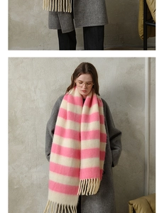 Detailed macro view of pink and white striped scarf with long fringes and soft texture