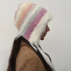 Colorful striped knit trapper hat with white faux fur lining and ear flaps for winter