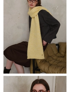 Detail of bright yellow knitted scarf showing rich wool texture and premium craftsmanship
