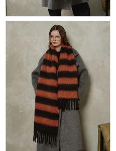 Close-up of thick plaid scarf featuring brown and orange stripes with tassel details