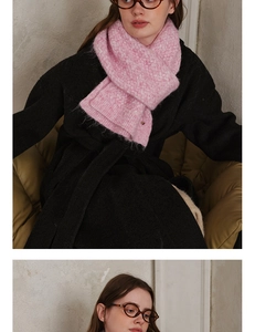 Detail of soft pink plush knit scarf showing fuzzy texture and metal accent on the end